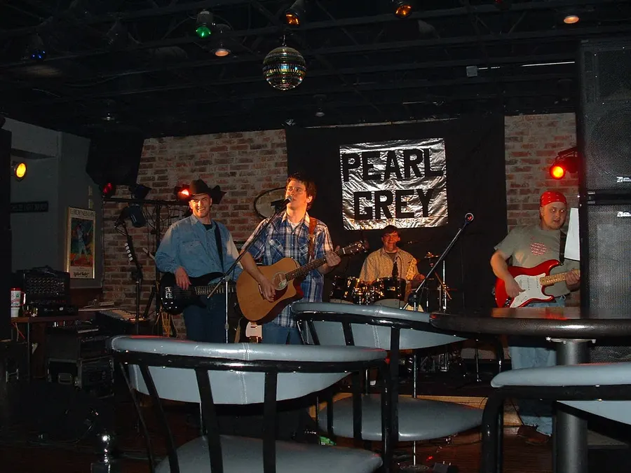 Pearl Grey on stage under the Pearl Grey banner, 2000s